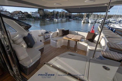 Luxurious 2026 Princess S65 yacht interior with elegant seating and scenic marina view.