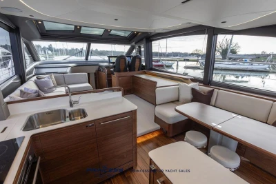 Luxurious interior of 2026 Princess S65 yacht with modern kitchen and seating area.