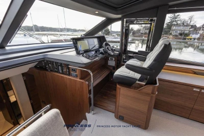 Luxurious 2026 Princess S65 yacht helm with modern controls and panoramic windows.