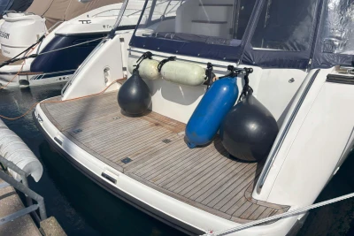 Stern view of 2004 Princess 45 Flybridge Motor Yacht with fenders and teak deck.