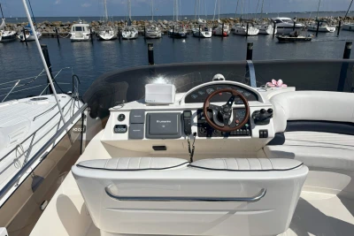 Flybridge helm of 2004 Princess 45 Motor Yacht in marina setting.