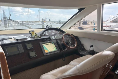 Helm of 2004 Princess 45 Flybridge Motor Yacht with navigation equipment and leather seating.