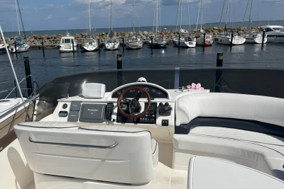 Flybridge of 2004 Princess 45 yacht with marina view in the background.