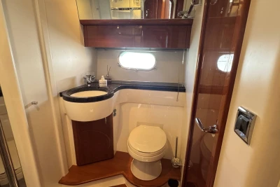 Luxurious bathroom in 2006 Princess 42 yacht with modern fixtures and elegant wood accents.