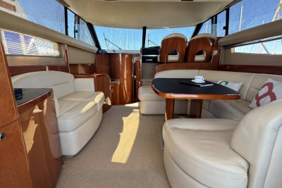 Luxurious interior of a 2006 Princess 42 yacht with elegant seating and dining area.