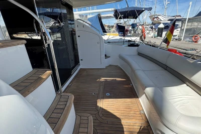 Luxurious 2006 Princess 42 yacht deck with wooden flooring and comfortable seating.