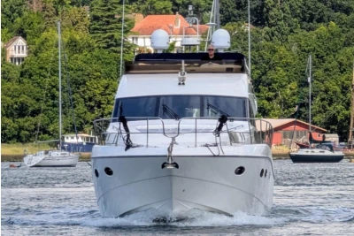 Luxury Princess 54 yacht cruising on a scenic waterway, 2009 model.