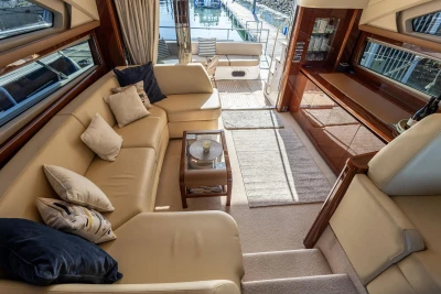 Luxurious interior of 2009 Princess 54 yacht with beige seating and elegant decor.
