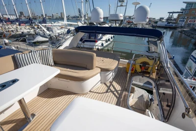 Luxurious 2009 Princess 54 yacht with spacious deck and seating at marina.