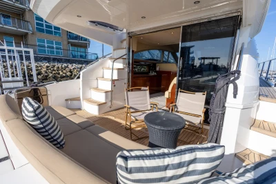 Luxurious 2009 Princess 54 yacht deck with seating, table, and stairs.