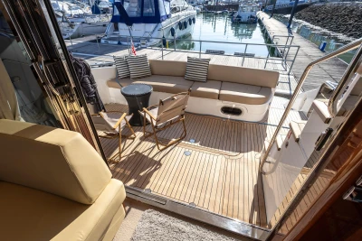 Luxurious 2009 Princess 54 yacht deck with seating, docked at marina.