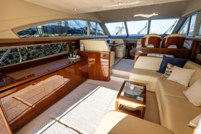 Luxurious interior of a 2009 Princess 54 yacht with elegant seating and polished wood finishes.