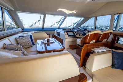Luxurious interior of 2009 Princess 54 yacht with plush seating and modern helm.