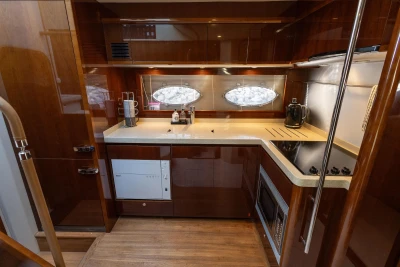 Luxurious kitchen in a 2009 Princess 54 yacht with modern appliances and wood finish.