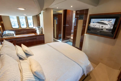 Luxurious bedroom interior of 2009 Princess 54 yacht with elegant furnishings and decor.