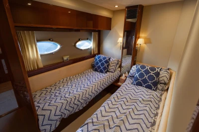 Luxurious twin cabin in 2009 Princess 54 yacht with nautical decor.