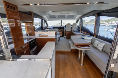 Luxurious interior of 2018 Princess S60 yacht with modern kitchen and seating area.