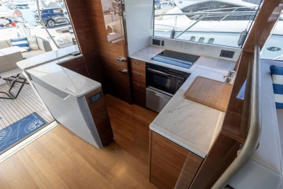 Luxurious 2018 Princess S60 yacht kitchen with modern appliances and elegant wood finish.