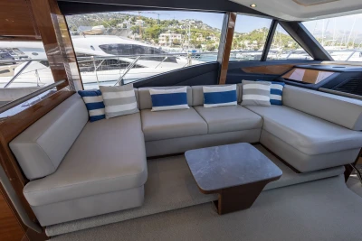 Luxurious interior of 2018 Princess S60 yacht with elegant seating and scenic marina view.