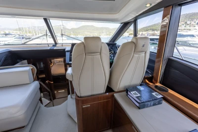 Luxurious interior of 2018 Princess S60 yacht with leather seating and panoramic windows.