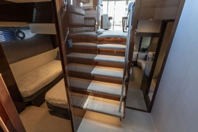 Luxurious interior of 2018 Princess S60 yacht with elegant staircase and cozy seating area.