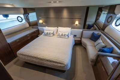 Luxurious 2018 Princess S60 yacht bedroom with elegant decor and ocean view.