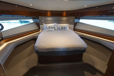 Luxurious cabin interior of 2018 Princess S60 yacht with elegant bedding and panoramic windows.