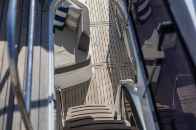 Luxurious 2018 Princess S60 yacht interior with wooden deck and cushioned seating.
