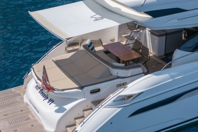 Luxurious 2018 Princess S60 yacht with spacious deck and seating area on blue water.