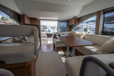 Luxurious interior of 2023 Princess F45 yacht with elegant seating and wooden table.