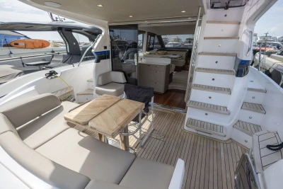Luxurious 2023 Princess F45 yacht interior with elegant seating and wooden table.