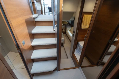 Interior of 2023 Princess F45 yacht featuring stairs, bathroom, and cabin area.