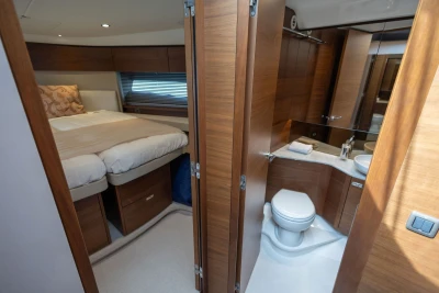 Luxurious 2023 Princess F45 yacht interior with bedroom and bathroom, featuring elegant wood finishes.