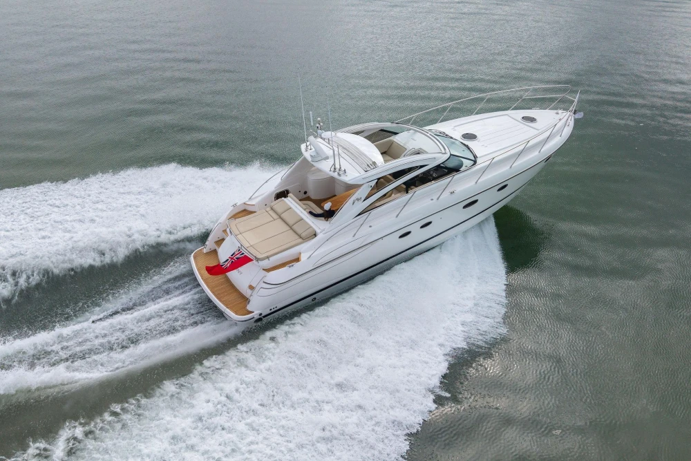 2006 Princess V48 yacht cruising on open water, aerial view.