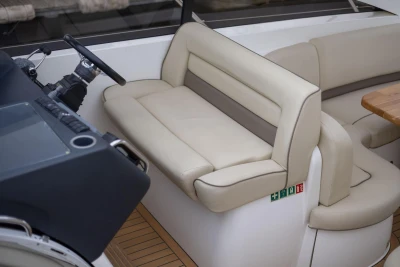 Luxurious seating area on a 2006 Princess V48 yacht with beige upholstery.