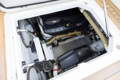 Engine compartment of a 2006 Princess V48 yacht, showcasing mechanical components and hoses.