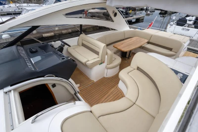 Luxurious 2006 Princess V48 yacht interior with elegant seating and wooden table.