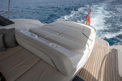2023 Princess V50 Open yacht with luxurious sunbed and ocean view.