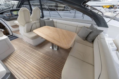 Luxurious 2023 Princess V50 Open yacht interior with elegant seating and wooden table.