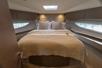 Luxurious bedroom interior of 2023 Princess V50 Open yacht with elegant bedding.