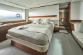 Luxurious bedroom interior of 2025 Princess F65 yacht with elegant design and sea view.