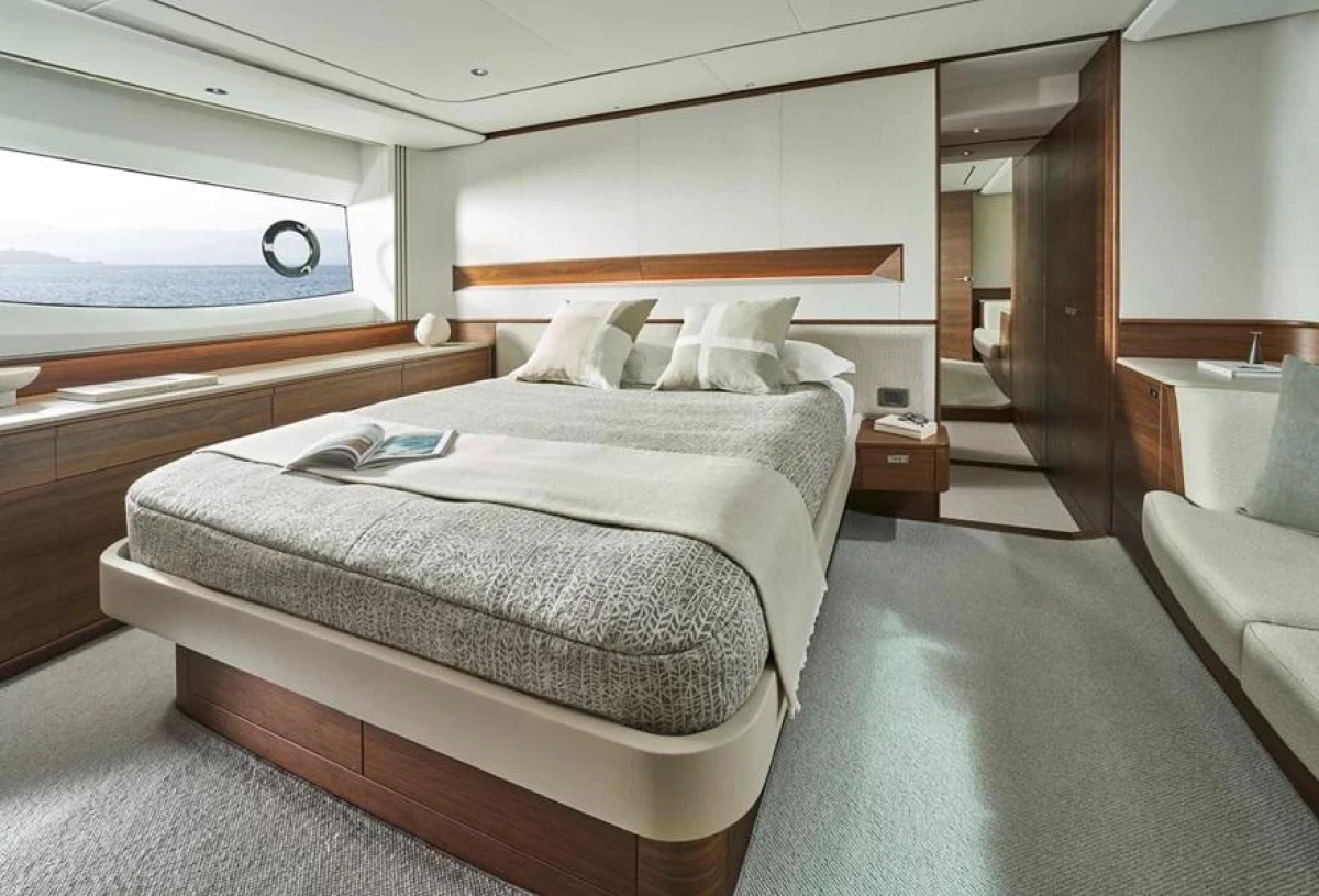 Luxurious bedroom interior of 2025 Princess F65 yacht with elegant design and sea view.