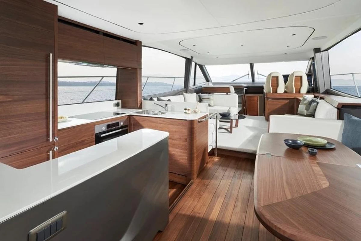 Luxurious interior of 2025 Princess F65 yacht with modern wood finishes and spacious seating.