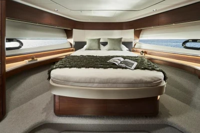Luxurious 2025 Princess F65 yacht bedroom with elegant decor and ocean view.