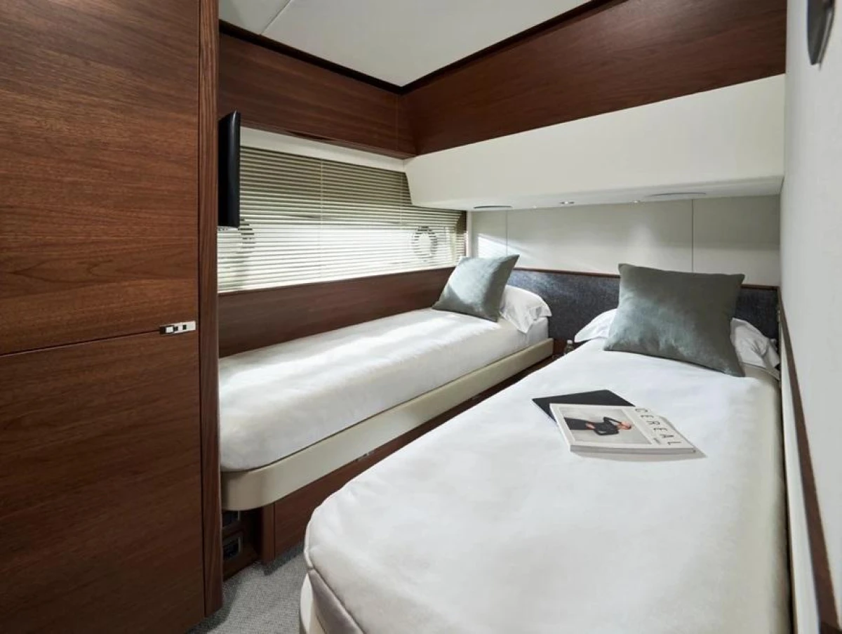 Luxurious twin cabin in 2025 Princess F65 yacht with modern decor and cozy bedding.