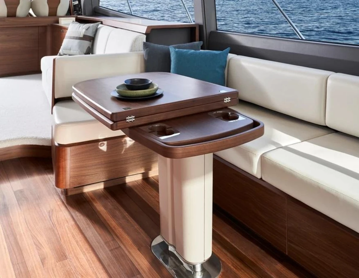 Luxurious interior of 2025 Princess F65 yacht with elegant wood and leather seating.