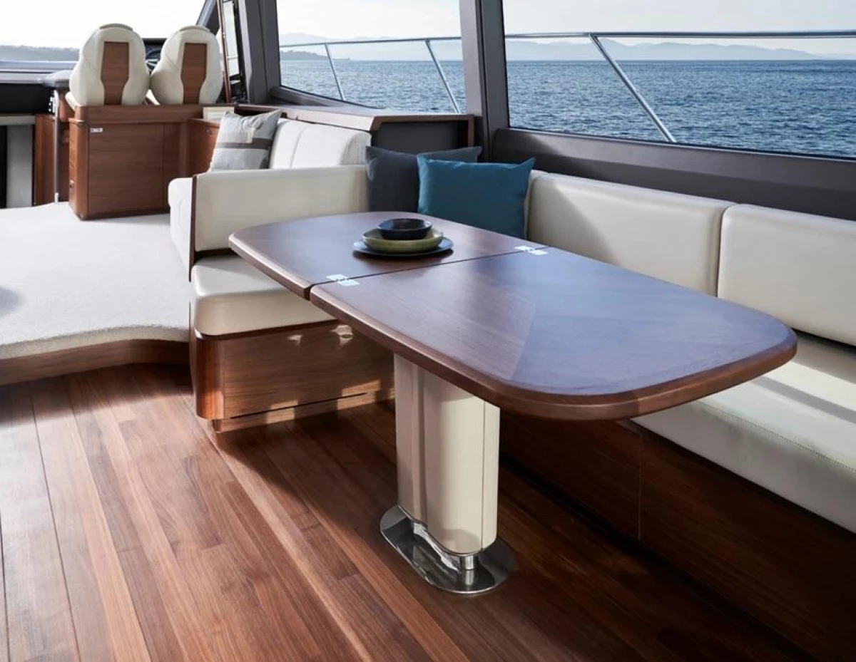 Luxurious interior of 2025 Princess F65 yacht with elegant wood finishes and ocean view.