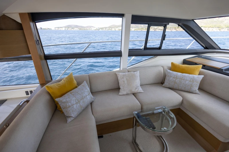Luxurious interior of 2018 Princess 49 yacht with elegant seating and ocean view.