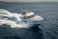 Luxurious 2018 Princess 49 yacht cruising swiftly on open sea.