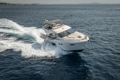Luxurious 2018 Princess 49 yacht cruising swiftly on open sea.